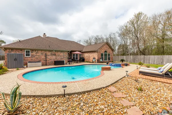 a view of a swimming pool with a yard