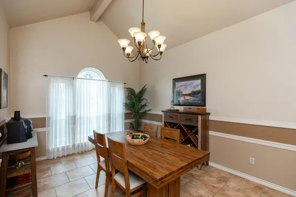 a dining room with a table and chairs