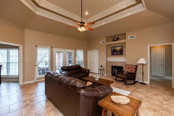 a living room with furniture and a fireplace