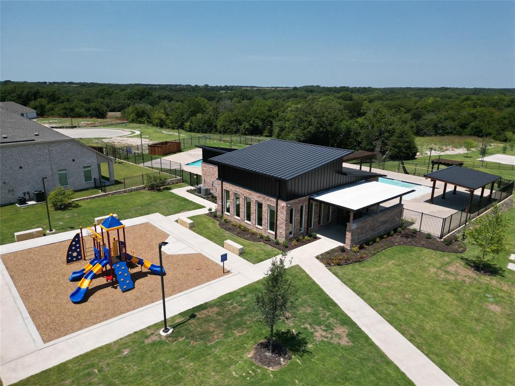 an aerial view of a house with swimming pool patio and outdoor seating