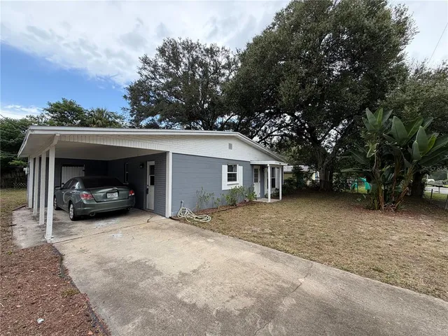 a view of a house with a space and trees