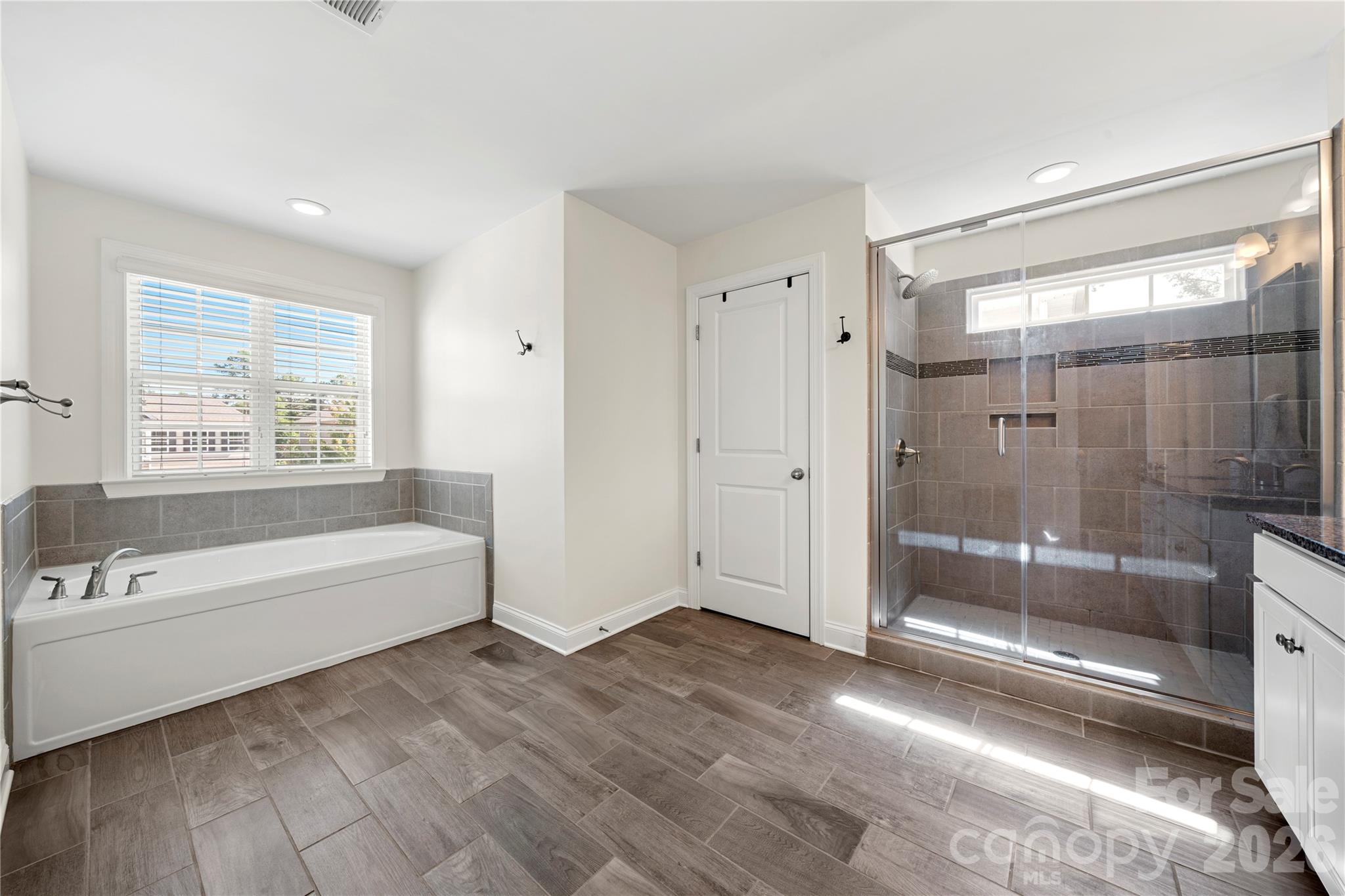 11266 Trailside Road Concord, NC 28027 - Photo 40 of 48 a spacious bathroom with a bathtub shower and toilet