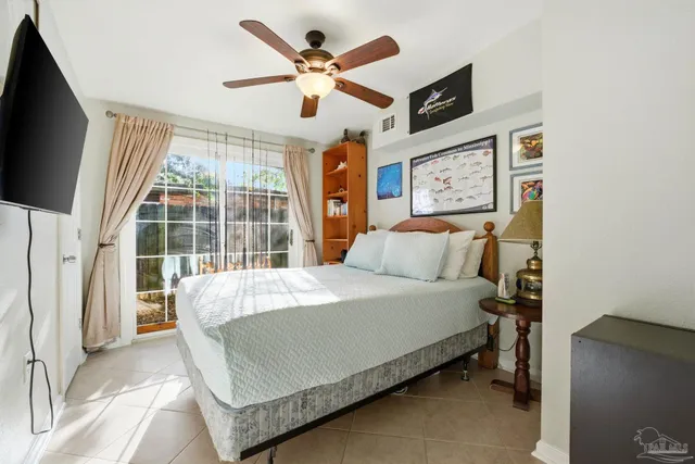 a bed sitting in a bedroom next to a window