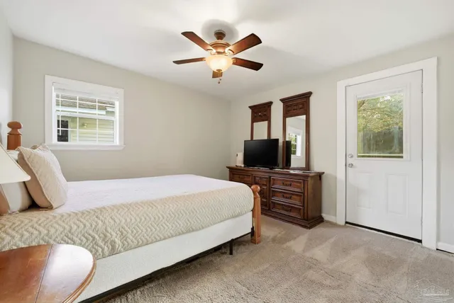 a bedroom with a large bed and a flat screen tv