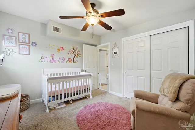 a bedroom with furniture and a rug