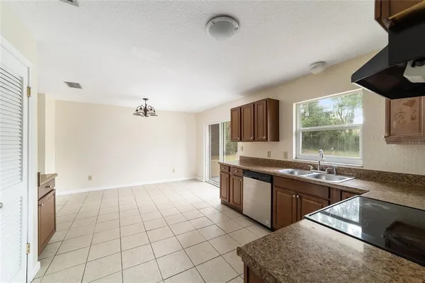 a kitchen with stainless steel appliances granite countertop a sink and a stove