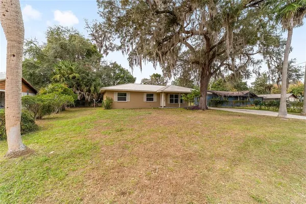 a front view of house with yard and green space