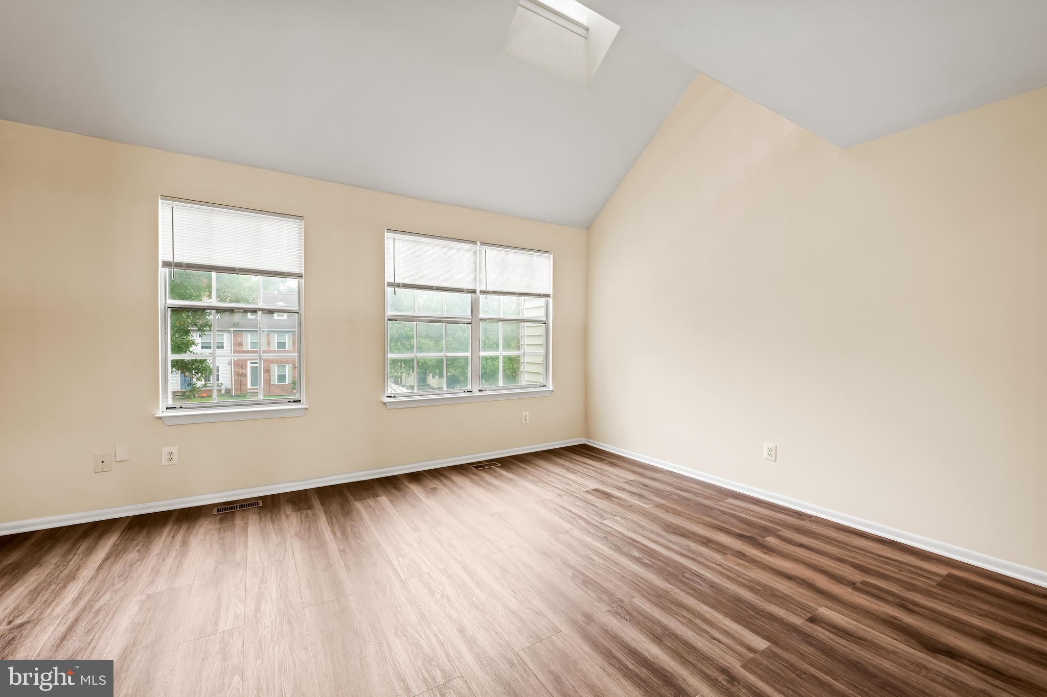 6953 Rockfield Road Baltimore, MD 21244 - Photo 15 of 31 an empty room with wooden floor and windows