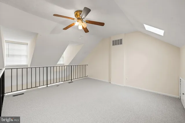 a view of a hallway with a chandelier fan and a chandelier