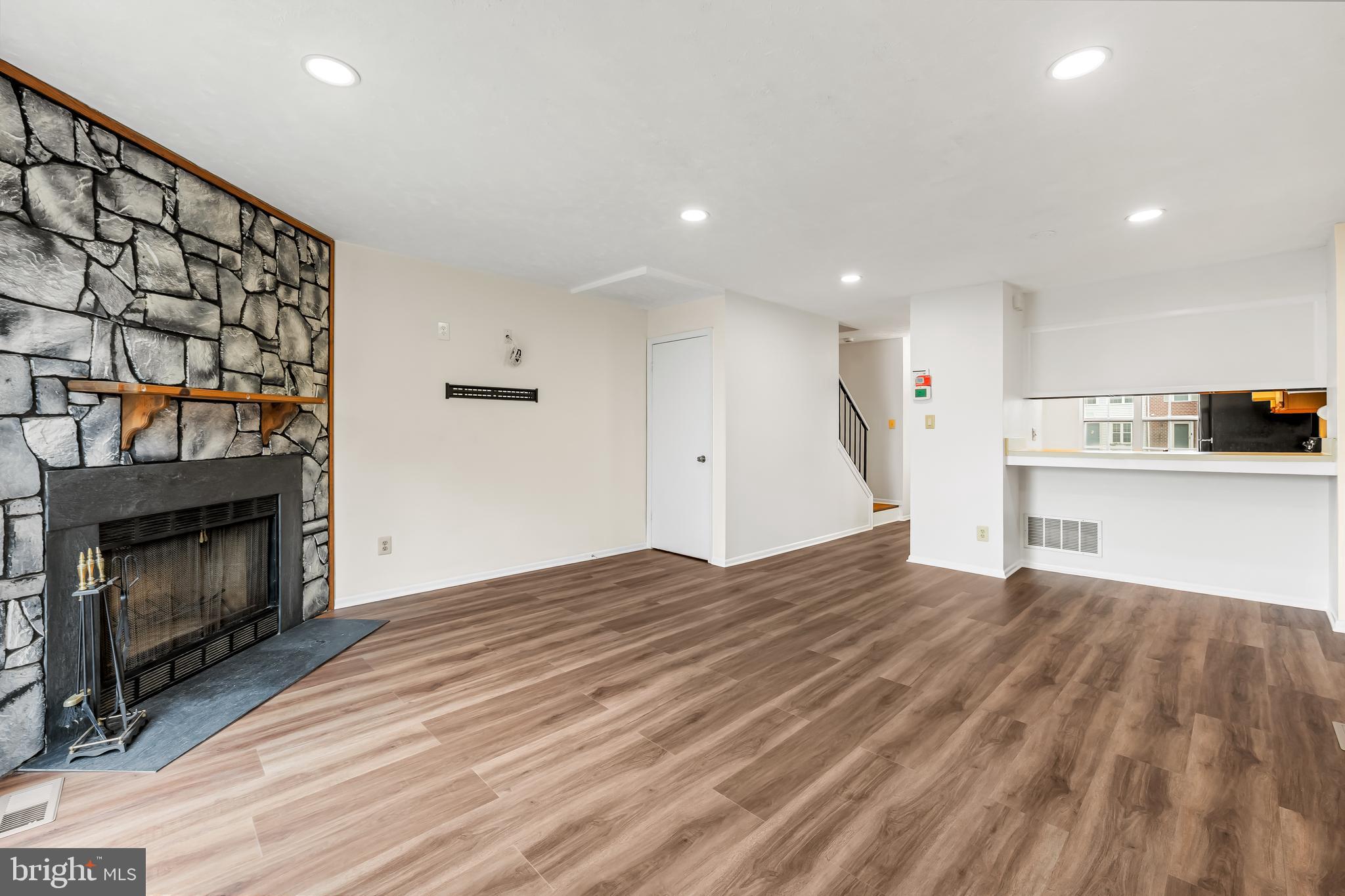 6953 Rockfield Road Baltimore, MD 21244 - Photo 2 of 31 a view of empty room with wooden floor and fireplace