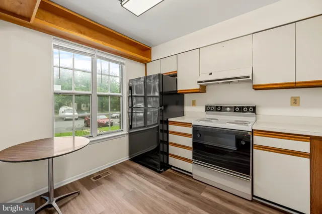a kitchen with stainless steel appliances a stove a refrigerator and cabinets