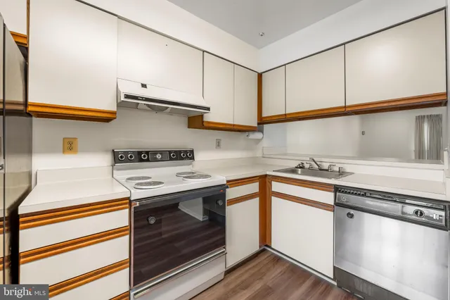 a kitchen with stainless steel appliances granite countertop a sink and cabinets