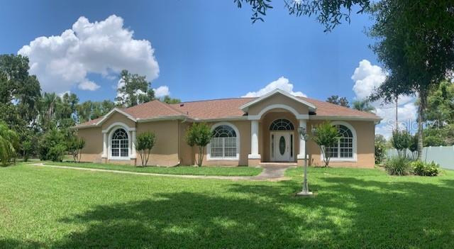 a front view of a house with a garden