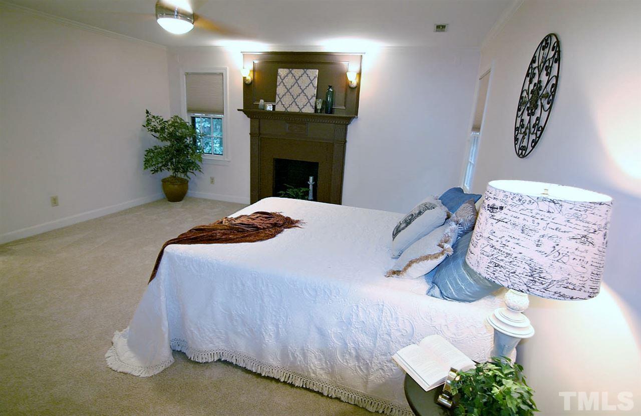 2001 Countrywood Road North Raleigh, NC 27615 - Photo 12 of 25 a bedroom with a bed and a fireplace