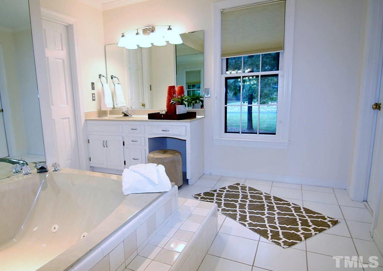 2001 Countrywood Road North Raleigh, NC 27615 - Photo 13 of 25 a bathroom with a bathtub and shower