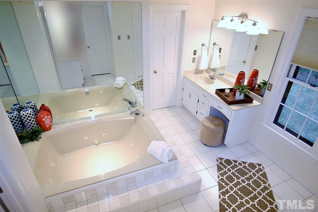 2001 Countrywood Road North Raleigh, NC 27615 - Photo 14 of 25 a bathroom with a tub sink and mirror