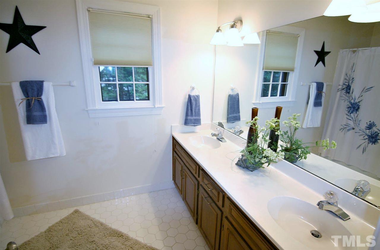 2001 Countrywood Road North Raleigh, NC 27615 - Photo 15 of 25 a bathroom with a sink and a mirror