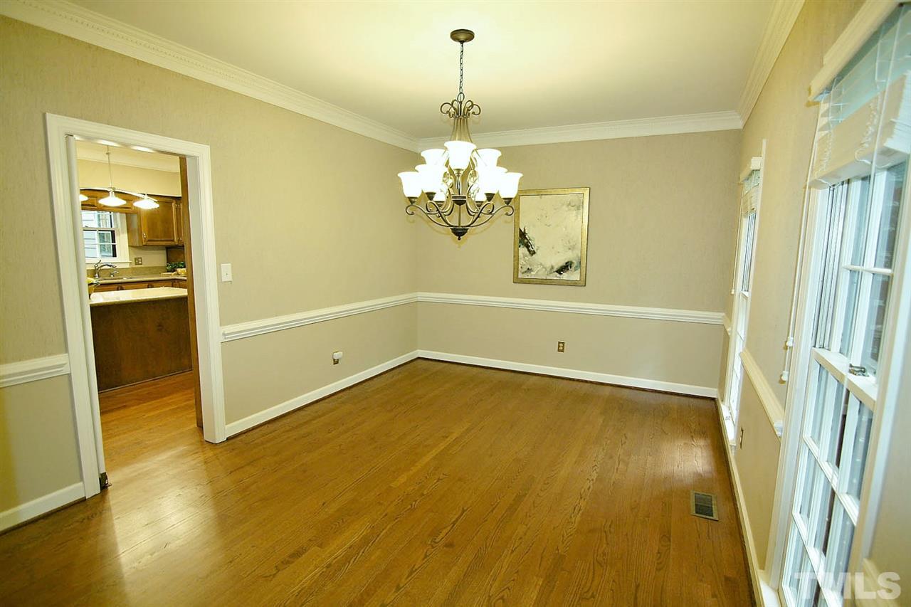 2001 Countrywood Road North Raleigh, NC 27615 - Photo 3 of 25 a view of a room with wooden floor and chandelier