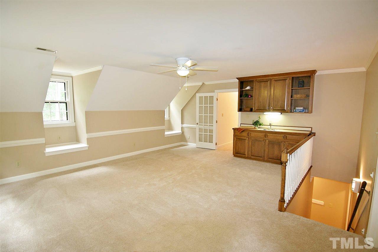 2001 Countrywood Road North Raleigh, NC 27615 - Photo 21 of 25 a living room with furniture a flat screen tv and a window