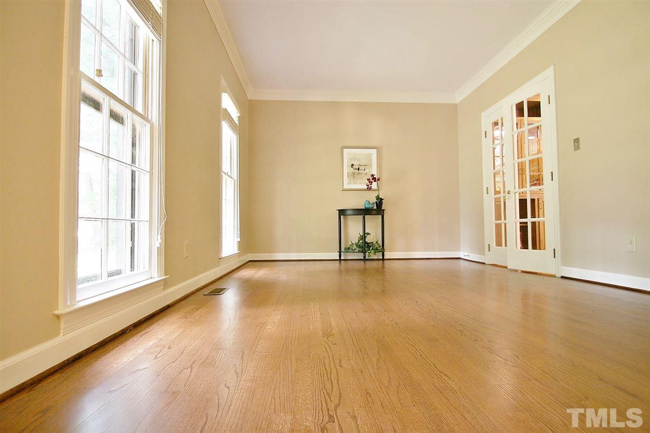 2001 Countrywood Road North Raleigh, NC 27615 - Photo 4 of 25 a view of an empty room with wooden floor and a window