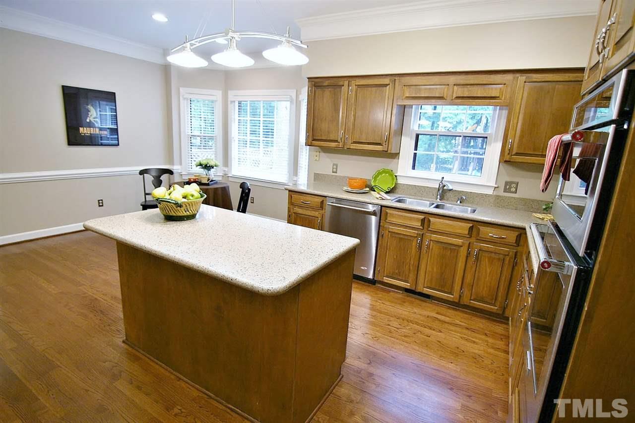2001 Countrywood Road North Raleigh, NC 27615 - Photo 6 of 25 a kitchen with a sink stove and wooden cabinets
