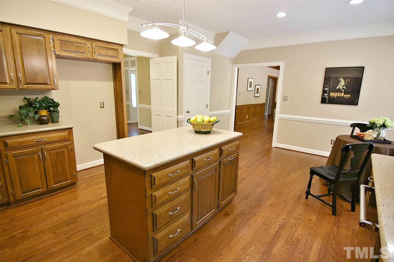 2001 Countrywood Road North Raleigh, NC 27615 - Photo 7 of 25 a living room with stainless steel appliances kitchen island granite countertop furniture and wooden floor