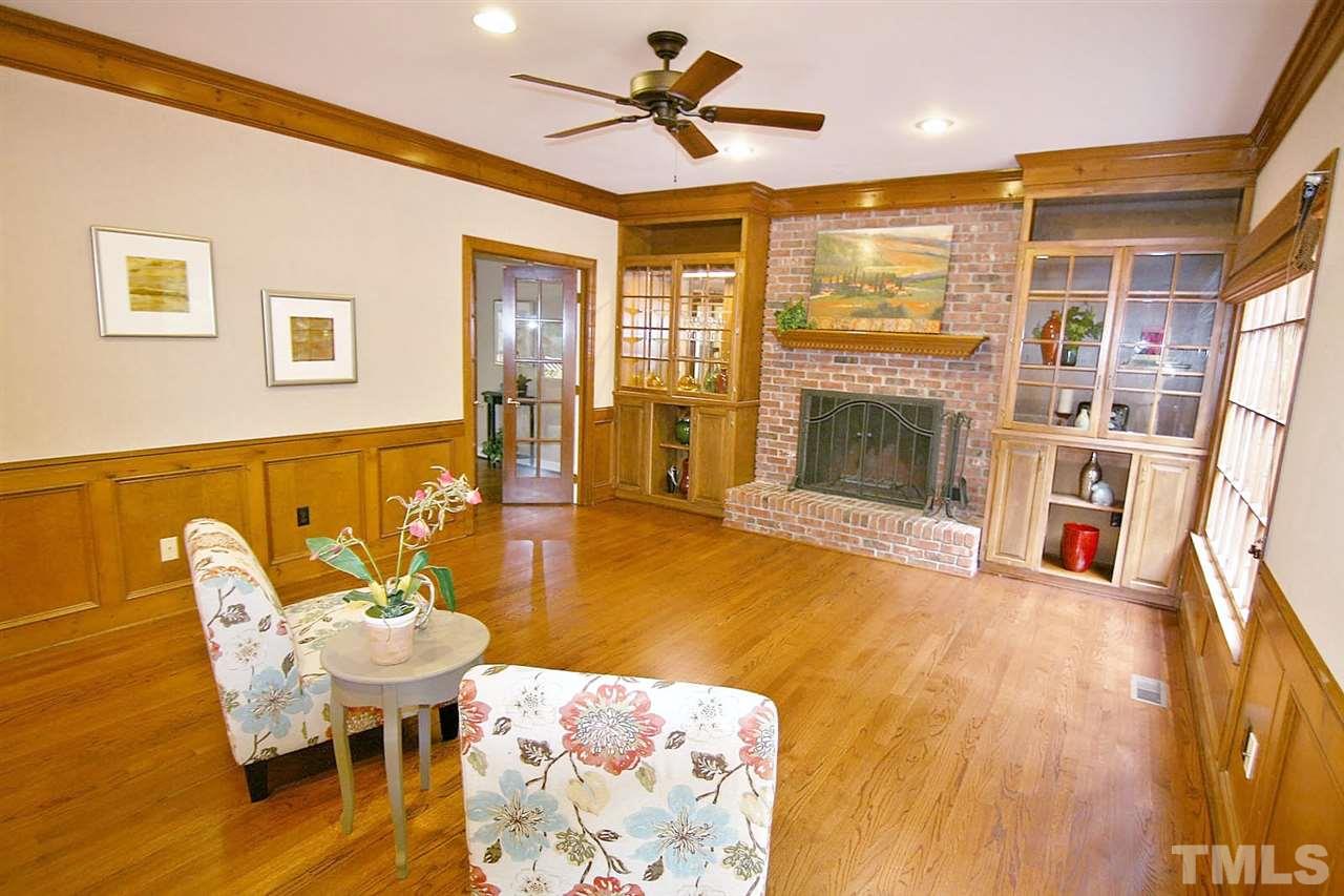 2001 Countrywood Road North Raleigh, NC 27615 - Photo 10 of 25 a living room with furniture a fireplace and a flat screen tv
