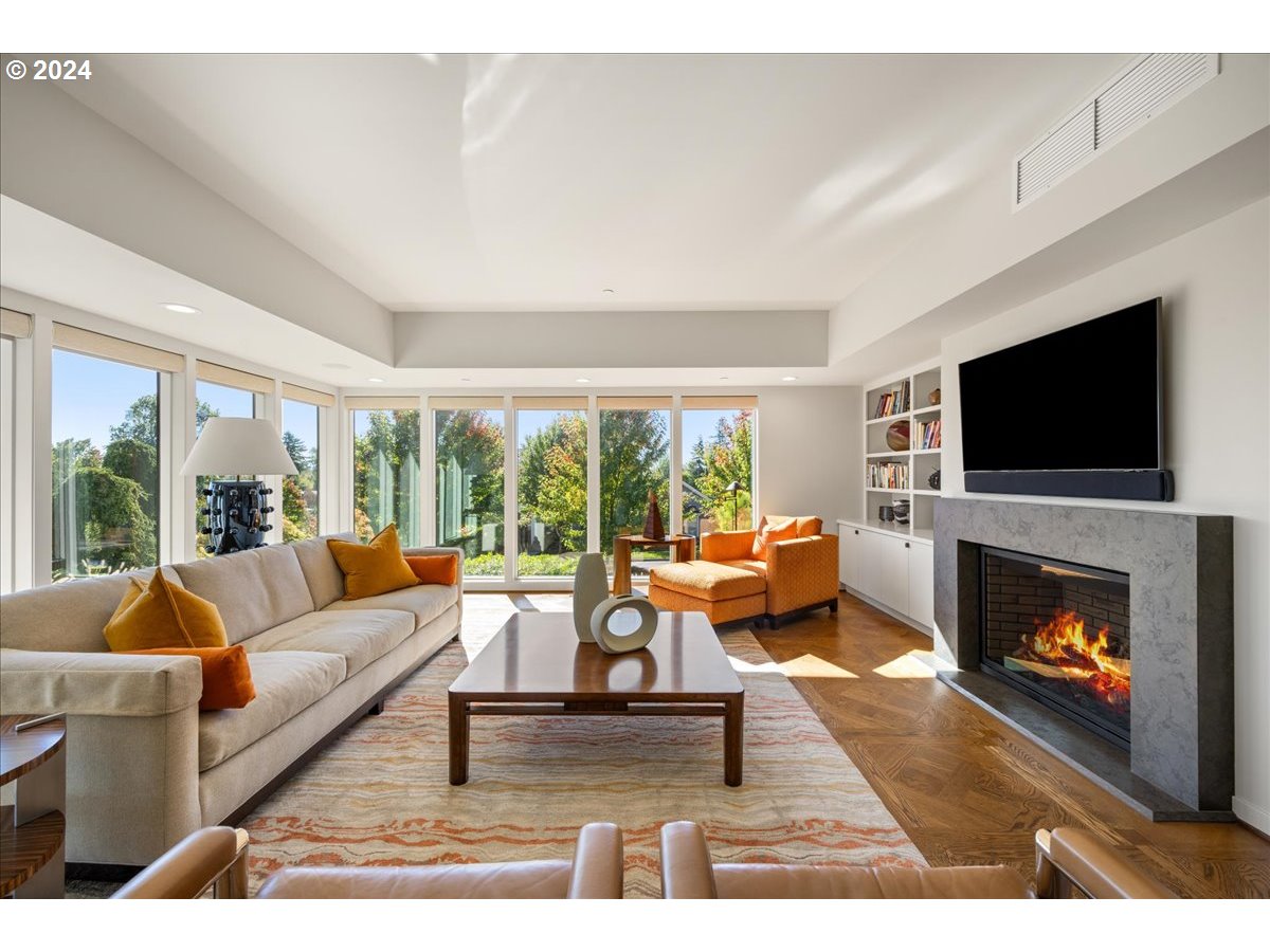 1933 Highlands Loop Lake Oswego, OR 97034 - Photo 11 of 48 a living room with furniture a flat screen tv and a fireplace