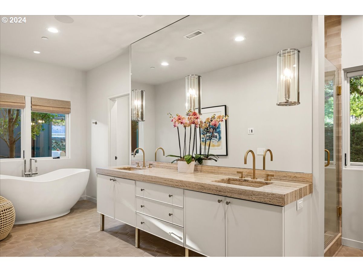 1933 Highlands Loop Lake Oswego, OR 97034 - Photo 20 of 48 a bathroom with a double vanity sink a mirror and a bathtub