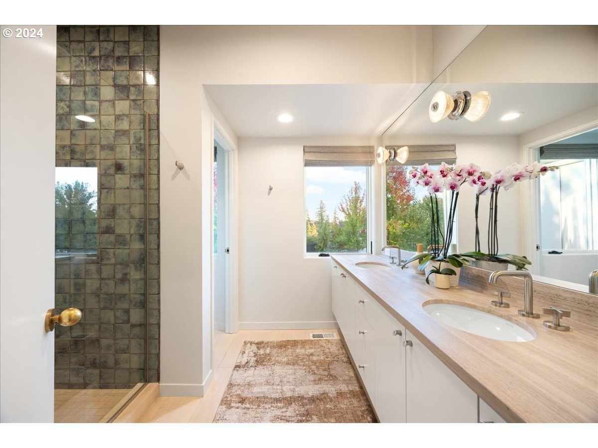 1933 Highlands Loop Lake Oswego, OR 97034 - Photo 35 of 48 a bathroom with a sink a large mirror and a shower