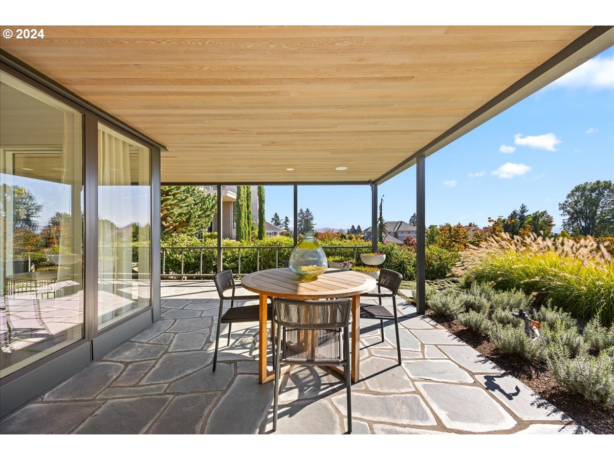 1933 Highlands Loop Lake Oswego, OR 97034 - Photo 7 of 48 a patio with glass top table and chairs