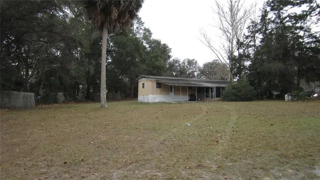 a front view of house with yard and trees