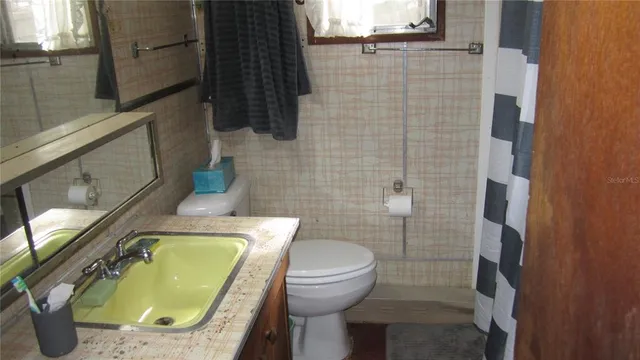 a bathroom with a toilet and a sink