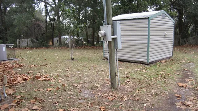 a view of a house with a yard and sitting area