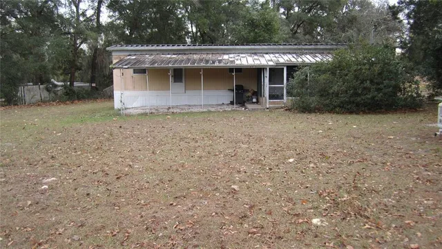 a view of a house with a backyard