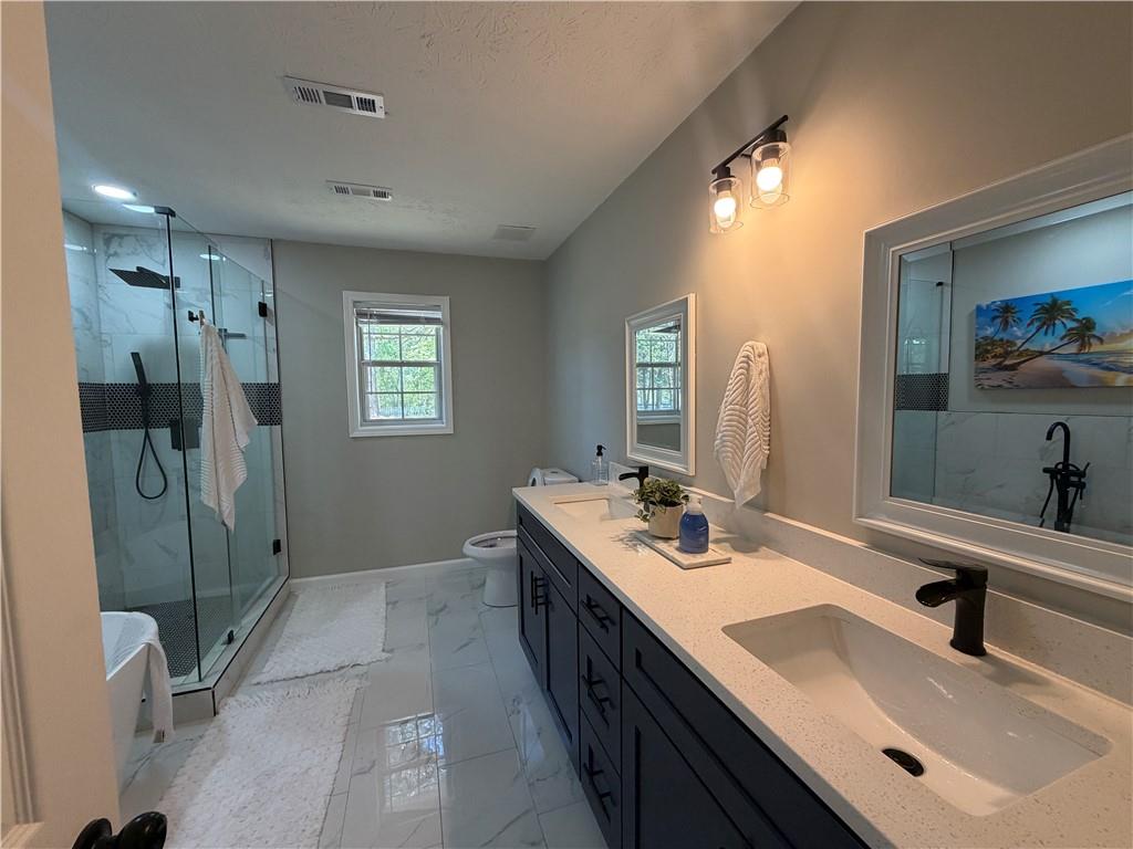 934 Bay Ridge Drive Lawrenceville, GA 30045 - Photo 55 of 78 a bathroom with a double vanity sink a mirror and shower