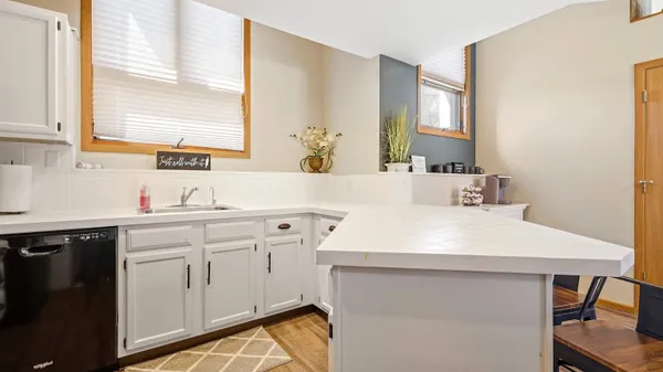 a kitchen with a sink cabinets and window