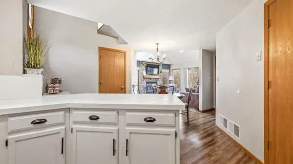 a view of washer and dryer with kitchen in the background