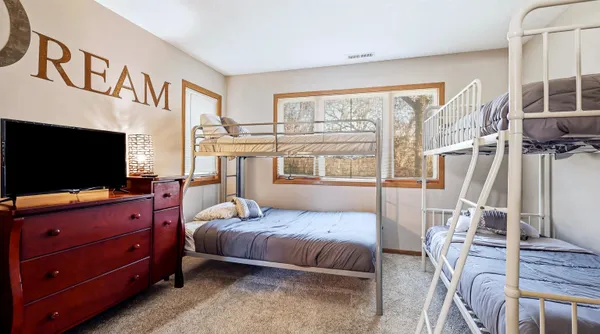 a bedroom with furniture and a flat screen tv