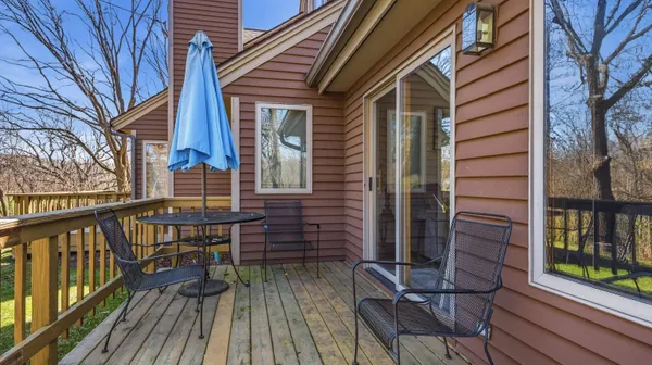 a view of a balcony with wooden floor and fence