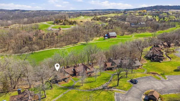 an aerial view of a house with a yard and lake view