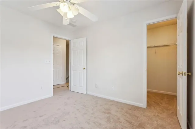 an empty room with a empty space and a ceiling fan