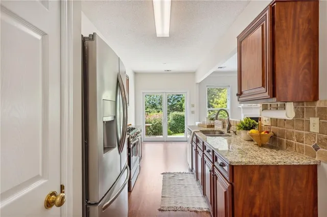 a kitchen with a window a sink and a refrigerator