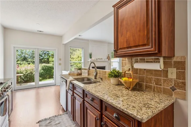 a kitchen with granite countertop a sink and a window