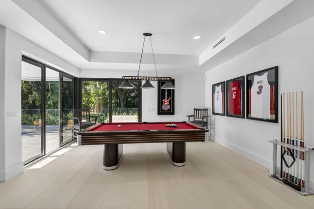 a spacious bedroom with a bed and a flat screen tv