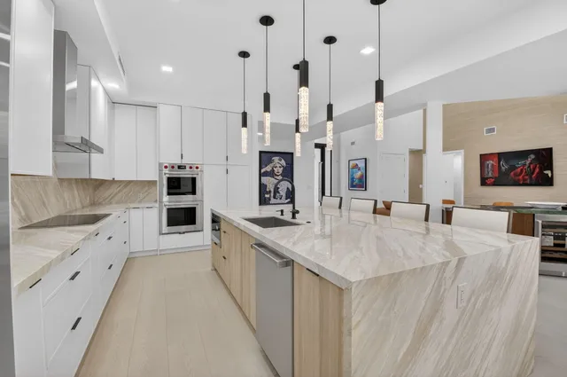 a living room with a sink furniture and a flat screen tv