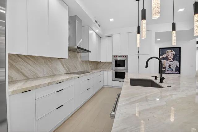 a spacious bathroom with a granite countertop sink a mirror a vanity and a shower