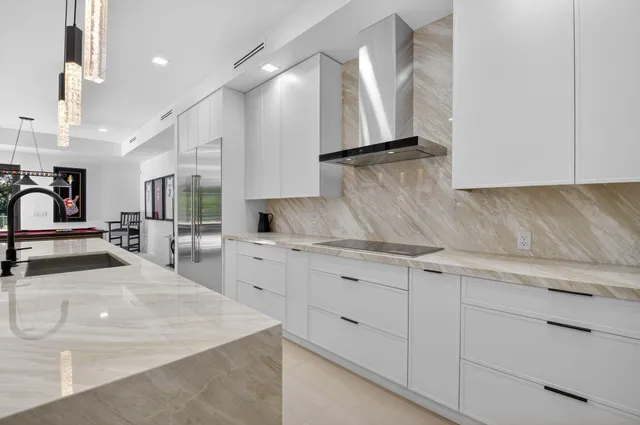 a spacious bathroom with a granite countertop sink a mirror a vanity and a shower
