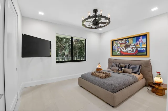 a bedroom with two beds and a chandelier