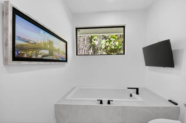 a view of a tennis ground with large trees